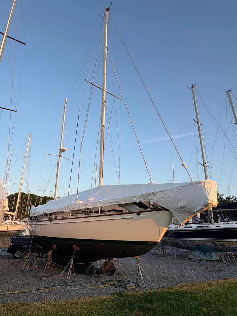 Slide: The Image of 1984 Shannon Aegean 51 sailboat covered and docked on land at sunset. - 38