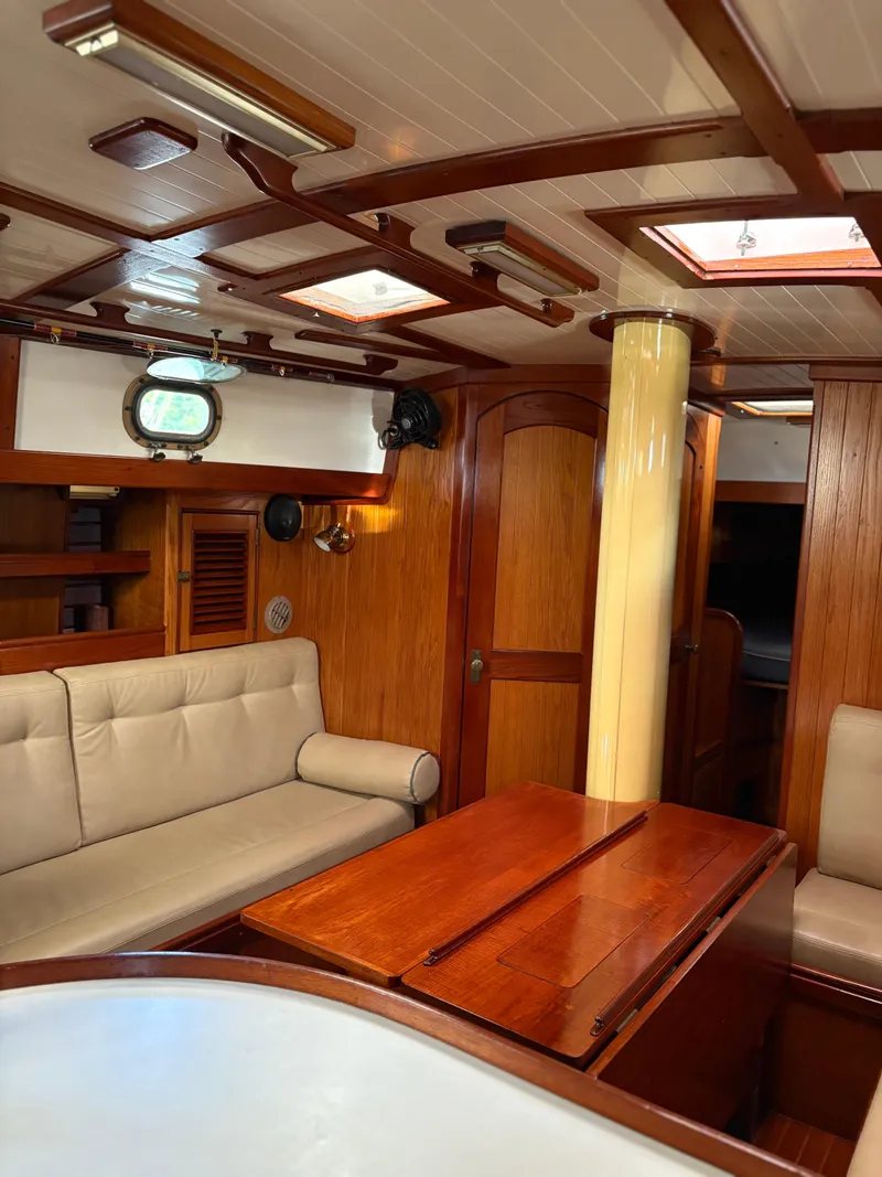 Slide: The Image of Interior of 1984 Shannon Aegean 51 yacht with wooden furnishings and beige seating. - 6