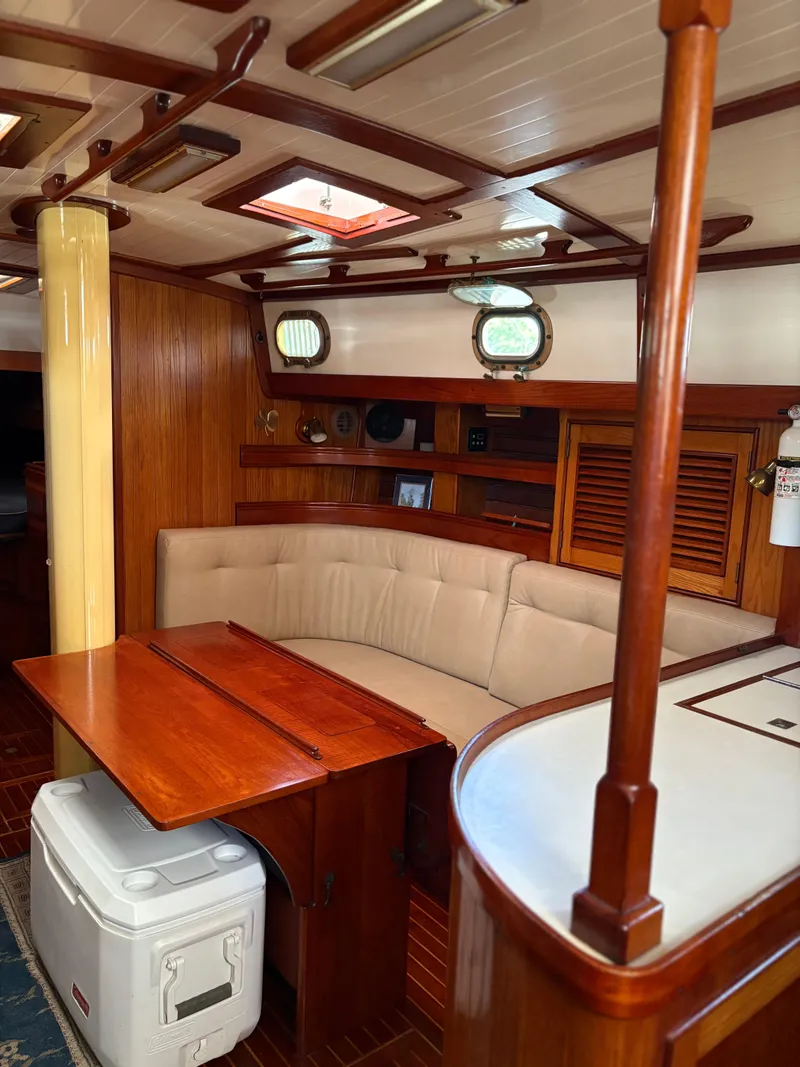 Slide: The Image of Interior of 1984 Shannon Aegean 51 sailboat with wooden furnishings and beige seating. - 9