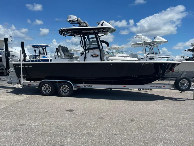 The Image of 2022 Sportsman Masters 267OE Bay Boat on trailer under blue sky. - 0