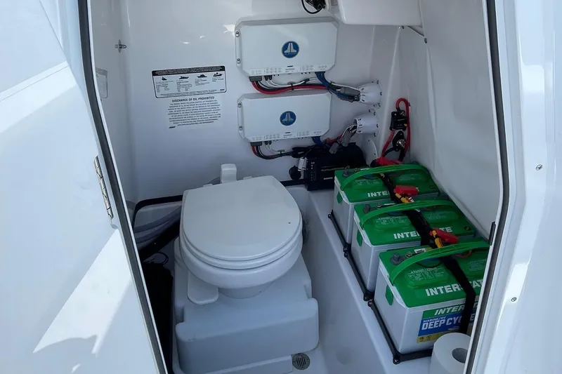Slide: The Image of 2022 Sportsman Masters 267OE Bay Boat interior with toilet and battery storage. - 11