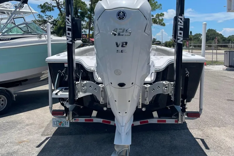 Slide: The Image of 2022 Sportsman Masters 267OE Bay Boat with Yamaha V8 engine, parked on a trailer. - 2