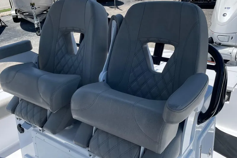 Slide: The Image of Two gray cushioned seats on a 2022 Sportsman Masters 267OE Bay Boat. - 6