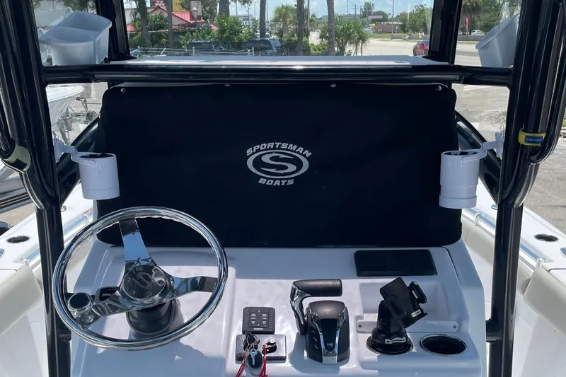 Slide: The Image of 2022 Sportsman Masters 267OE Bay Boat dashboard with steering wheel and controls. - 8