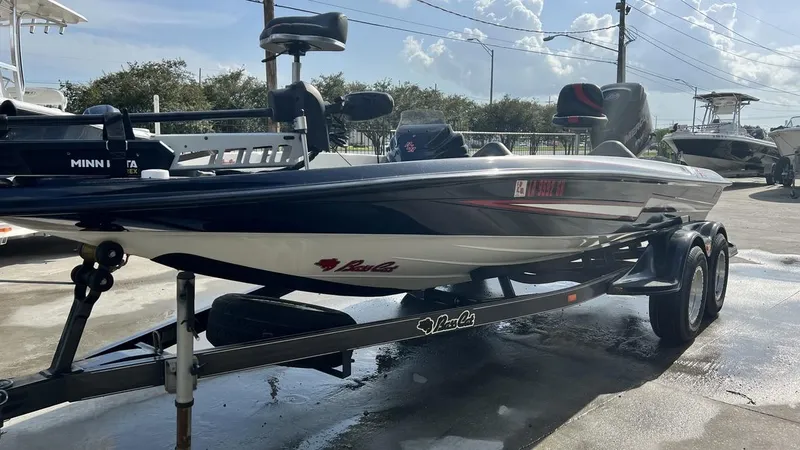 Slide: The Image of 2018 Bass Cat Pantera Classic fishing boat on trailer in a marina. - 14