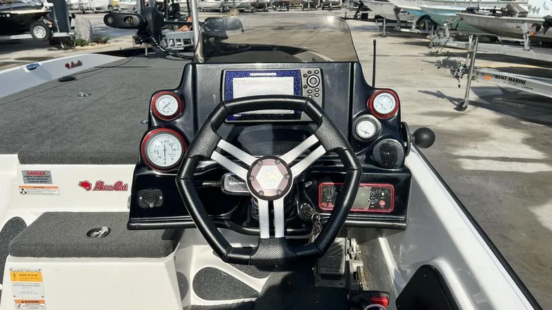 Slide: The Image of 2018 Bass Cat Pantera Classic boat dashboard with steering wheel and gauges. - 18