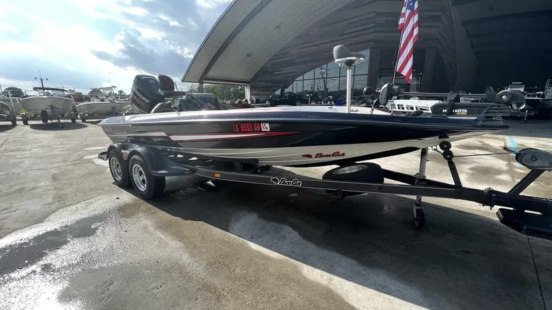 Slide: The Image of 2018 Bass Cat Pantera Classic boat on a trailer at a marina. - 19