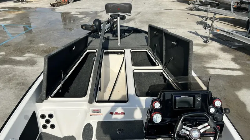 Slide: The Image of 2018 Bass Cat Pantera Classic fishing boat interior with open storage compartments and control console. - 4