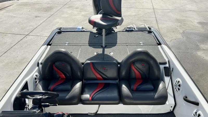 Slide: The Image of 2018 Bass Cat Pantera Classic boat interior with black and red seats. - 9