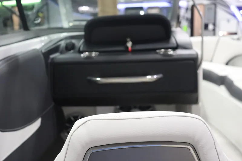 Slide: The Image of Interior of 2023 Crownline 240SS boat, featuring sleek black and white seating. - 10