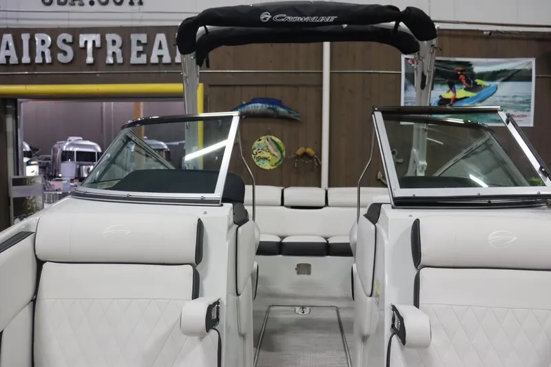 Slide: The Image of 2023 Crownline 240SS boat interior with white seating and black accents. - 12