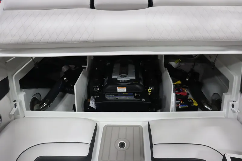Slide: The Image of 2023 Crownline 240SS boat engine compartment with cushioned seating. - 14