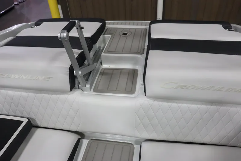 Slide: The Image of 2023 Crownline 240SS boat interior with cushioned seating and step ladder. - 16