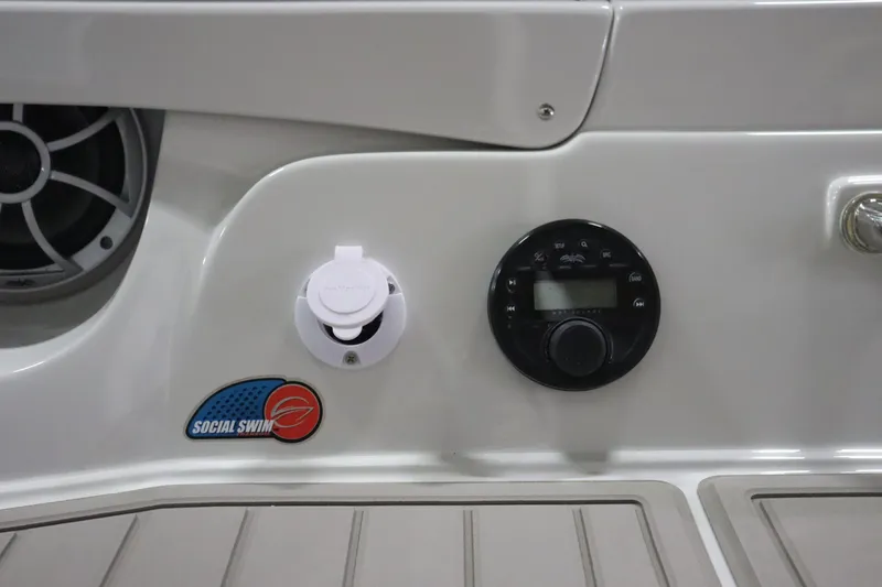 Slide: The Image of Control panel of 2023 Crownline 240SS boat with Social Swim system. - 17