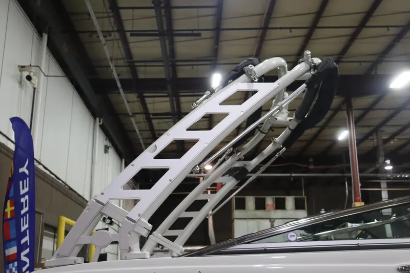 Slide: The Image of 2023 Crownline 240SS boat with wakeboard tower in a warehouse. - 19