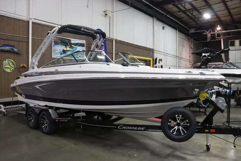 The Image of 2023 Crownline 240SS boat on trailer in indoor showroom. - 2
