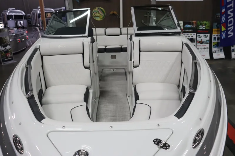 Slide: The Image of 2023 Crownline 240SS boat interior with white leather seating and open bow design. - 5