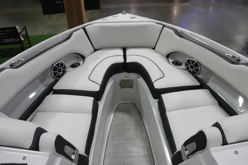 Slide: The Image of 2023 Crownline 240SS boat interior with white cushioned seating and built-in speakers. - 7