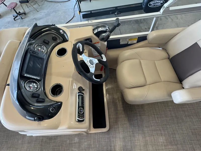 Slide: The Image of 2019 Sun Tracker SportFish 22 DLX boat dashboard with steering wheel and beige captain's chair. - 10