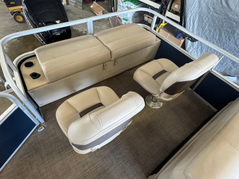 Slide: The Image of 2019 Sun Tracker SportFish 22 DLX interior with beige seating and carpeted flooring. - 13