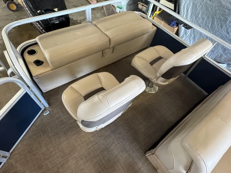 Slide: The Image of 2019 Sun Tracker SportFish 22 DLX interior with beige seating and cup holders. - 14