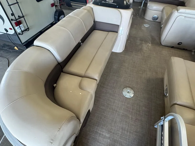 Slide: The Image of 2019 Sun Tracker SportFish 22 DLX interior with beige seating and spacious layout. - 5