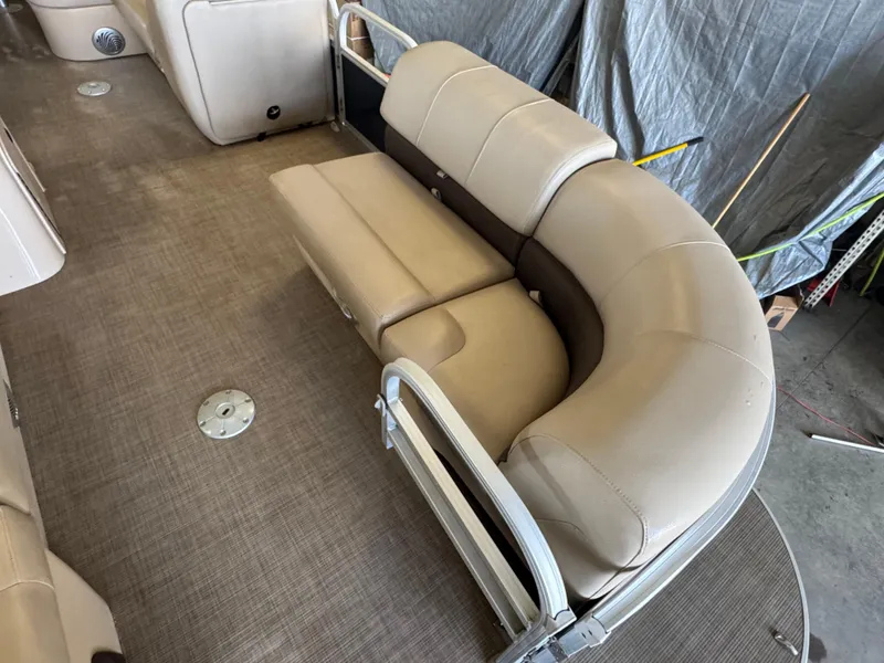 Slide: The Image of 2019 Sun Tracker SportFish 22 DLX interior with beige seating and carpeted flooring. - 6
