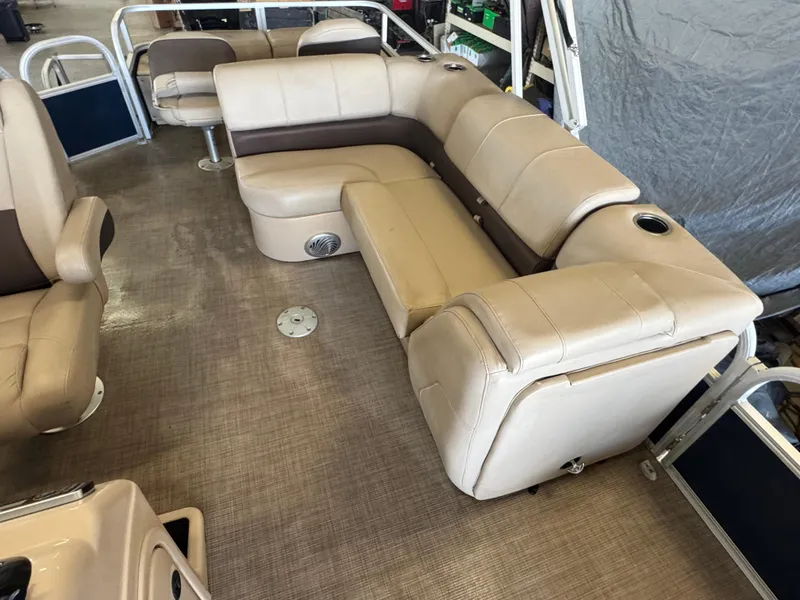 Slide: The Image of 2019 Sun Tracker SportFish 22 DLX pontoon boat interior with beige seating and cup holders. - 7