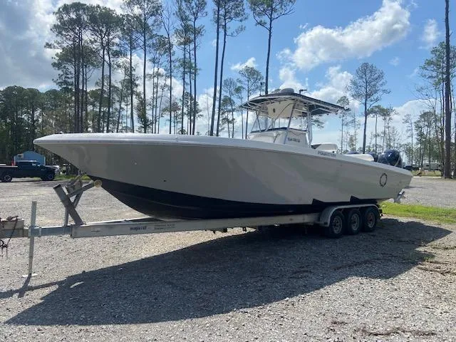 Slide: The Image of 2004 Fountain 34 CC boat on a trailer in a wooded area. - 0