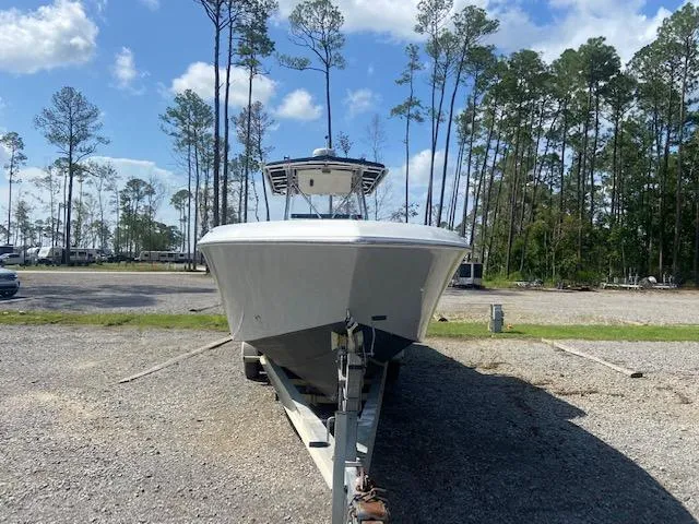 Slide: The Image of 2004 Fountain 34 CC boat on trailer in outdoor storage area. - 10
