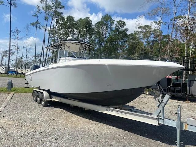 Slide: The Image of 2004 Fountain 34 CC boat on a trailer in a wooded area. - 11