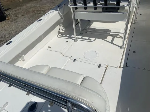 Slide: The Image of 2004 Fountain 34 CC boat interior with white seating and deck. - 12