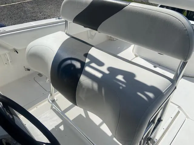 Slide: The Image of 2004 Fountain 34 CC boat seating with white and gray upholstery. - 17