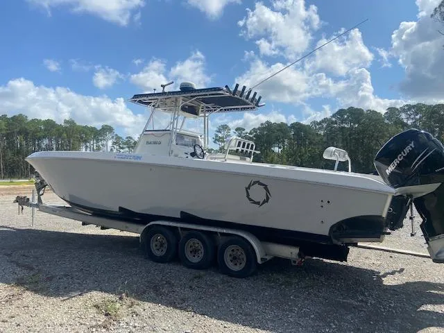 Slide: The Image of 2004 Fountain 34 CC boat on a trailer with Mercury outboard engines. - 2