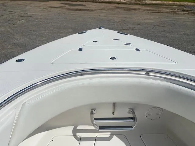 Slide: The Image of 2004 Fountain 34 CC boat bow view with white deck and seating. - 21