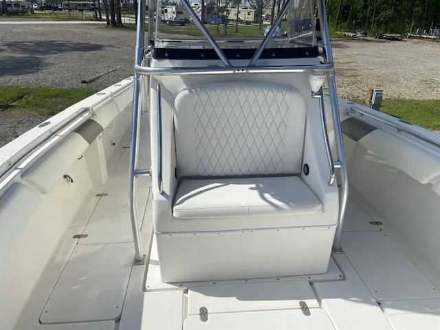 Slide: The Image of 2004 Fountain 34 CC boat interior with white cushioned seating. - 22