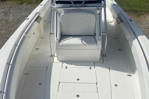 Slide: The Image of 2004 Fountain 34 CC boat interior with white seating and spacious deck. - 25