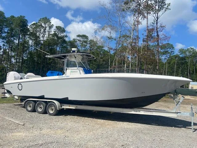 Slide: The Image of 2004 Fountain 34 CC boat on a trailer in a wooded area. - 4