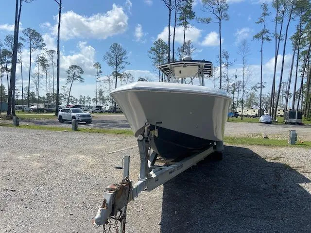 Slide: The Image of 2004 Fountain 34 CC boat on a trailer in a parking lot. - 8