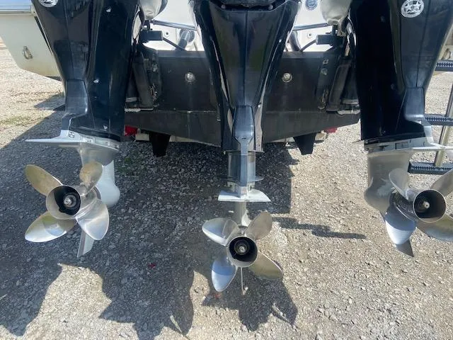 Slide: The Image of 2004 Fountain 34 CC boat with triple outboard engines and stainless steel propellers. - 9