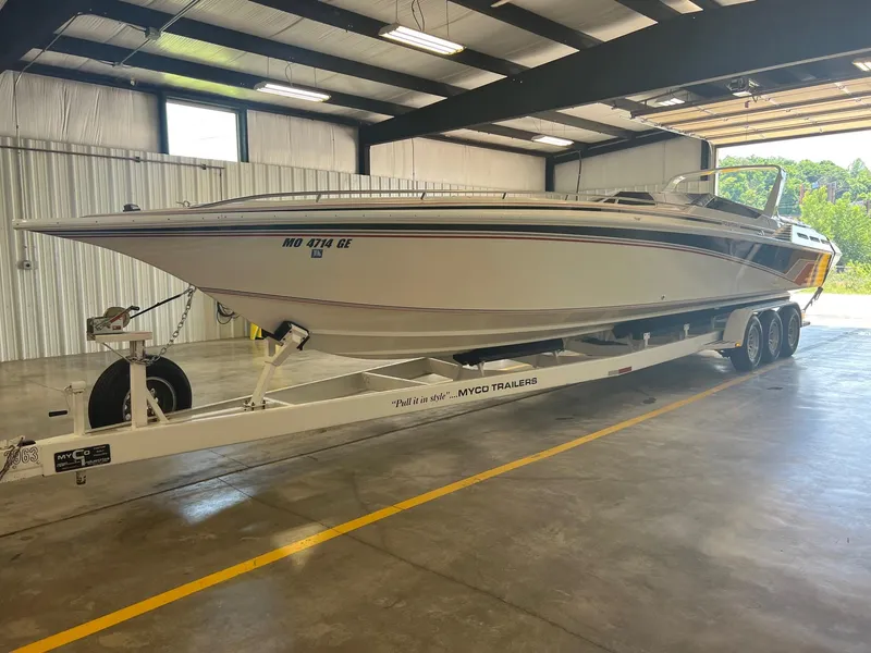 The Image of 1992 Fountain 42 Lightning speedboat on trailer in indoor storage facility. - 0