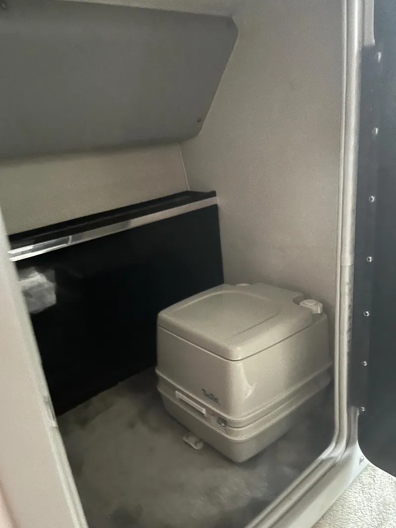 Slide: The Image of Compact marine toilet inside a 1992 Fountain 42 Lightning boat cabin. - 15