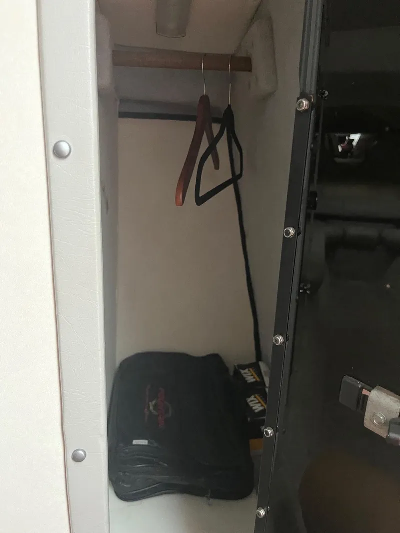 Slide: The Image of 1992 Fountain 42 Lightning boat closet with hangers and storage bag. - 16