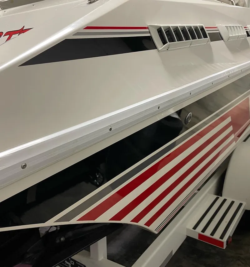 Slide: The Image of 1992 Fountain 42 Lightning boat with red and black stripes, side view. - 3