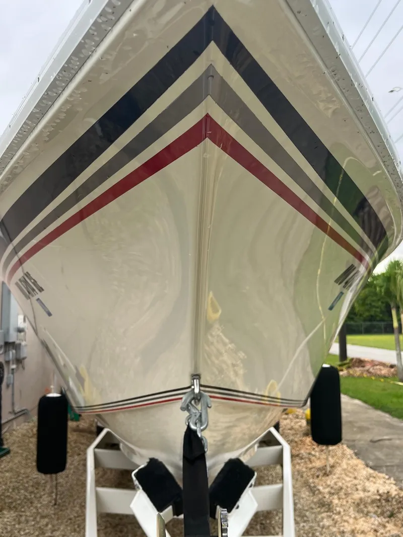 Slide: The Image of 1992 Fountain 42 Lightning boat with sleek design and colorful stripes on trailer. - 4