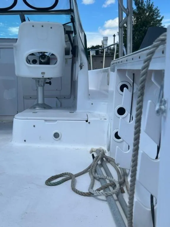 Slide: The Image of 2001 Pro-Line 25 Walkaround boat interior with captain's chair and storage compartments. - 10