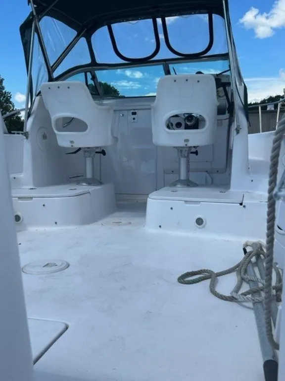 Slide: The Image of 2001 Pro-Line 25 Walkaround boat interior with seating and steering console. - 13