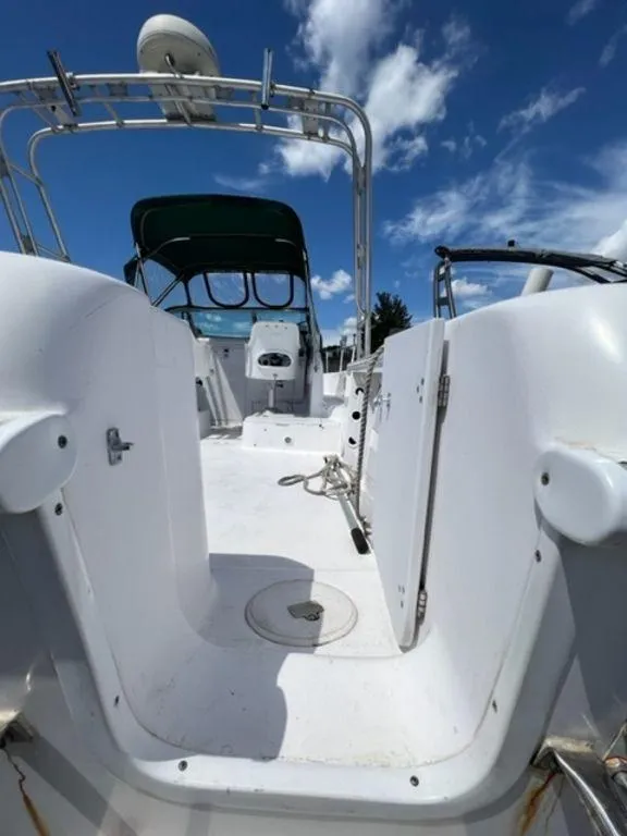 Slide: The Image of 2001 Pro-Line 25 Walkaround boat interior with open deck and blue sky. - 17