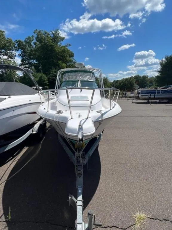 Slide: The Image of 2001 Pro-Line 25 Walkaround boat on trailer in outdoor lot. - 2