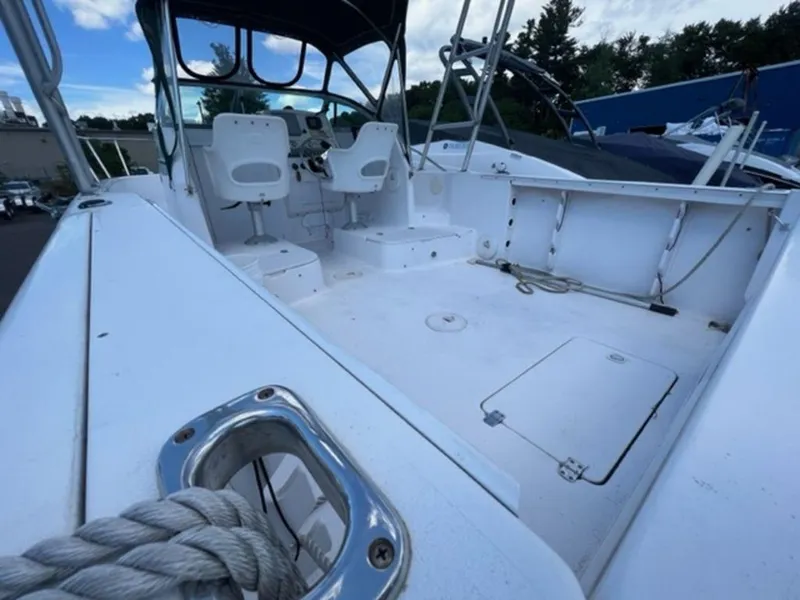 Slide: The Image of 2001 Pro-Line 25 Walkaround boat interior with seating and storage compartments. - 9
